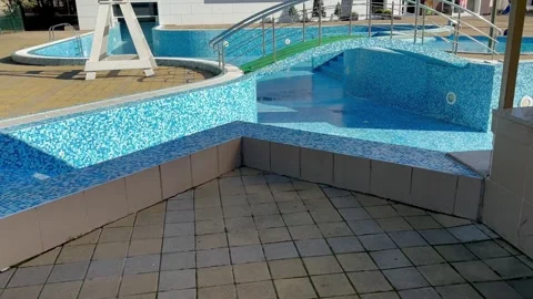 Empty swimming pool. Closed down swimming pool, restriction. Cleaning, repair wo 스톡 동영상 301074537