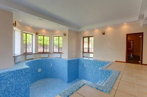 Empty swimming pool in house. first floor in cottage. Stock Photos