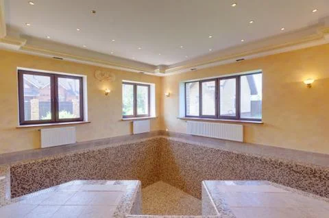 Empty swimming pool in house. first floor in cottage. Stock Photos