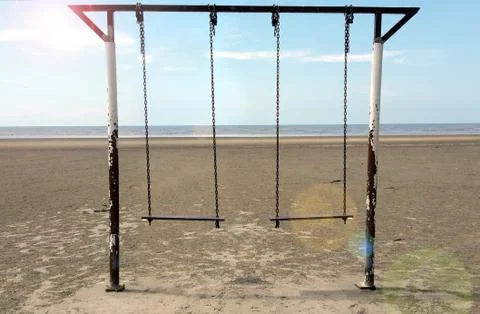 Empty swing at the beach Stock Photos