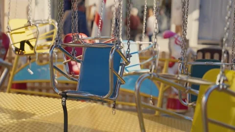 Empty swing carousel ride spinning at an amusement park Stock Footage 339098044