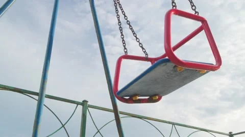 Empty swing on chains is swinging Stock Footage 295037586