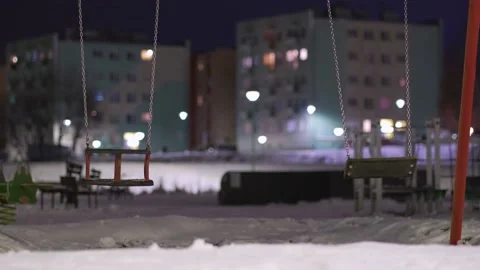 Empty swing on children playground during russian war invasion into Ukraine Stock Footage 233988419