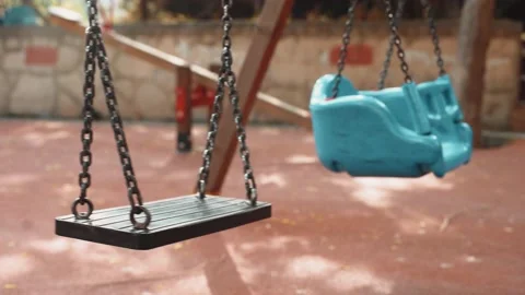 Empty swing on children playground Stock Footage 130444305