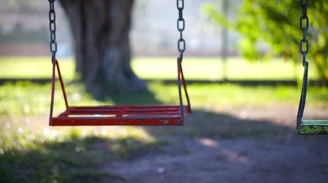 Empty swing in a children's playground Stock Footage