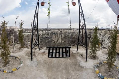 Empty swing framing panoramic rock formations in Goreme valley Cappadocia Stock Photos