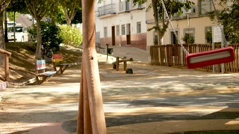 Empty swing moving in an enclosed park without children Stock-Footage 130755642