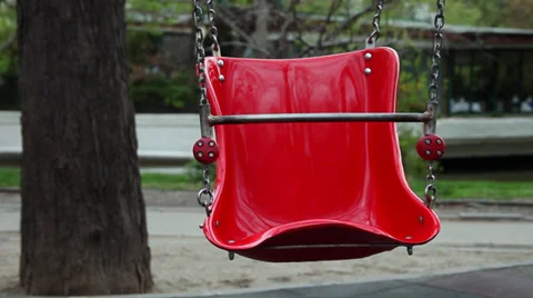 Empty swing moving on the playground, park, spring season Stock Footage 37123872