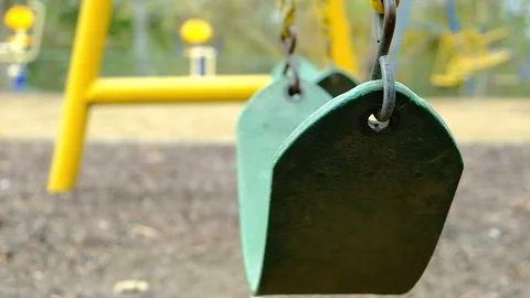 Empty swing moving in slow motion Stock Footage 273457768