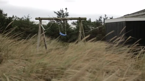 Empty swing moving in storm Stock Footage 77064567