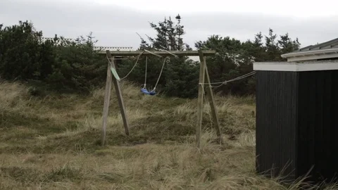 Empty swing moving in the wind Stock Footage 77064621