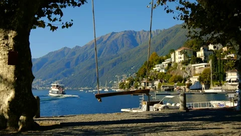 Empty Swing over Alpine Lake Maggiore with Mountain View in a Sunny Day 動画素材 191952487