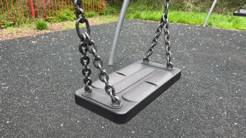 Empty swing in a park in England - close up Stock Footage 239629735