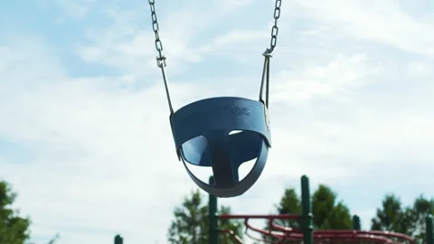 An empty swing on a playground Stock Footage 131238832