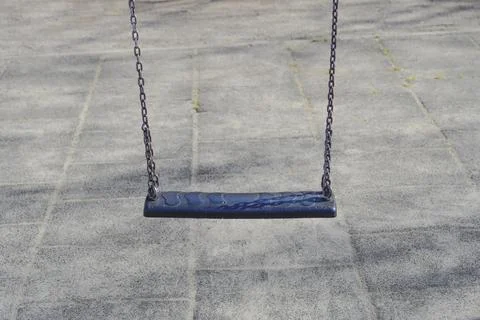 Empty Swing on a Playground. Stock Photos