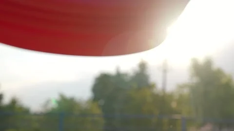 Empty swing in playground at sunset. Playground swing gently sways, inviting Stockbeeldmateriaal 311622381