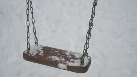 Empty swing on a playground in winter Видео 145730683