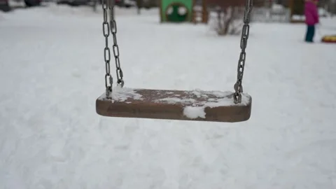 Empty swing on playground in winter Vídeo Stock 145730690