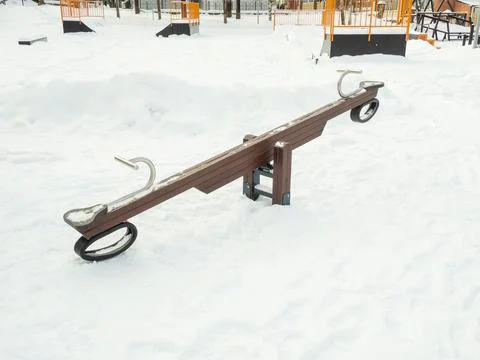 Empty swing at the playground in winter Stock Photos