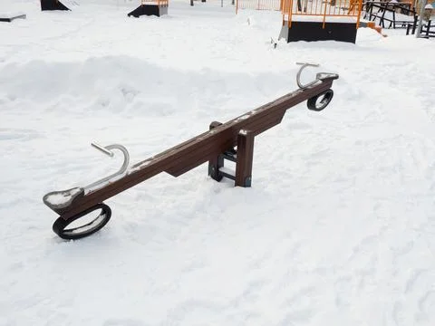 Empty swing at the playground in winter Stock Photos