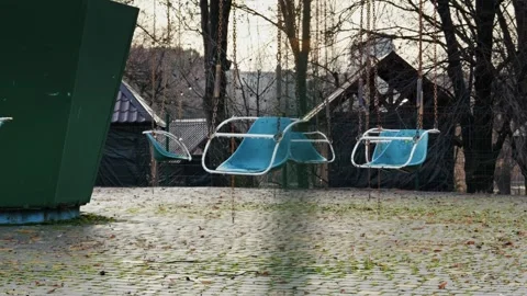 Empty Swing Ride in a Deserted and Abandoned Amusement Park Stock Footage 325967227