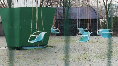 Empty Swing Ride Sits Idle in Abandoned Amusement Park Stock Footage 326313879