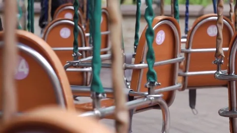 Empty swing seats of carousel on chains in the park Stock Footage 76835241