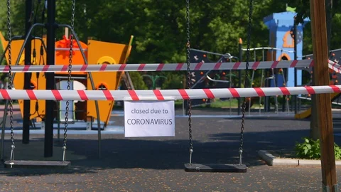 Empty swing set with caution tape to close off playground to children to help 스톡 동영상 129526106