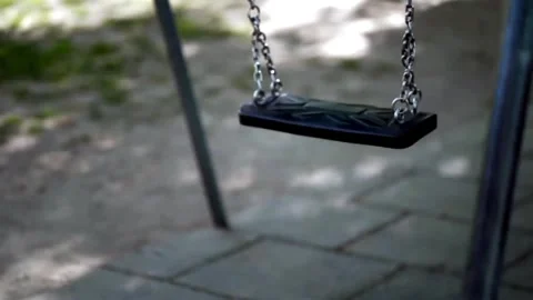 Empty Swing Set Moving Gently in Playground Stock Footage 328108094