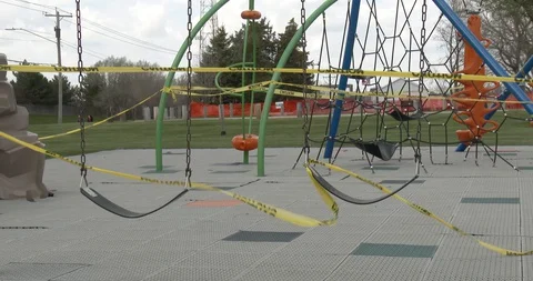 Empty Swing Set - Taped off - Closed Playground - Pandemic - COVID-19 Stock Footage 128783938