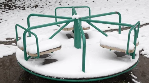Empty swing in the snow spinning. An empty Playground Stock-Footage 127651350