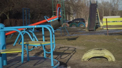 Empty Swing is Spinning on the Playground in the Yard Video stock 170370326