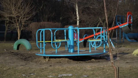 Empty Swing is Spinning on the Playground in the Yard Stock Footage 170734767