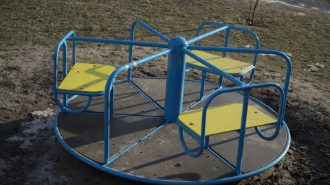 Empty Swing is Spinning on the Playground in the Yard Stock Footage 170735714