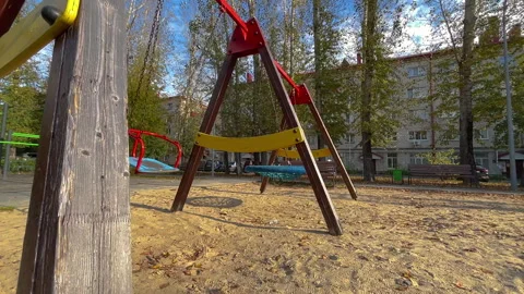 Empty swing swaying gently in the autumn breeze Video stock 314032228