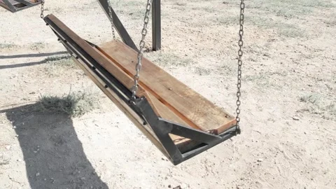 Empty swing is swinging on chain Video stock 321742379