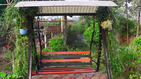 An Empty Swing is Swinging In The Garden Video stock 264514512