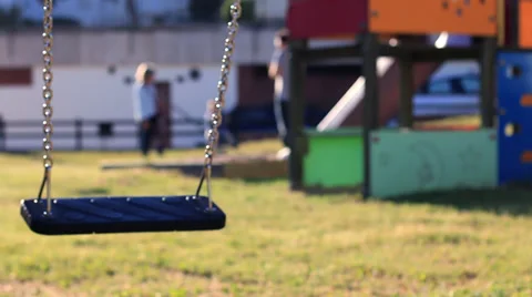 Empty swing swinging in the park Stock Footage 39382301