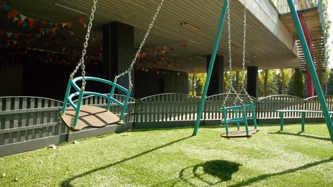 Empty Swing Swinging On The Playground On A Sunny Day Stock Footage 112382957
