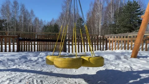 Empty swing in the winter park Video stock 172093294