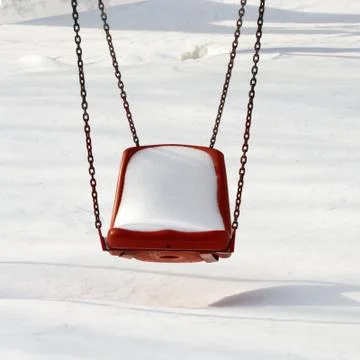 Empty swing in winter time Stock Photos