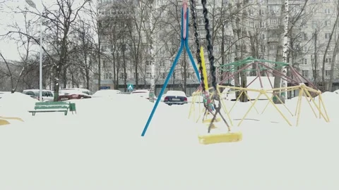 Empty swing in winter time with snow.4K Video stock 150321891