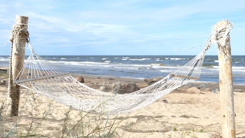 Empty swinging hammock in a sandy beach Stock Footage 95219645