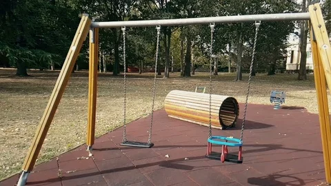 Empty swings with chains swaying at playground Stock-Footage 122197782