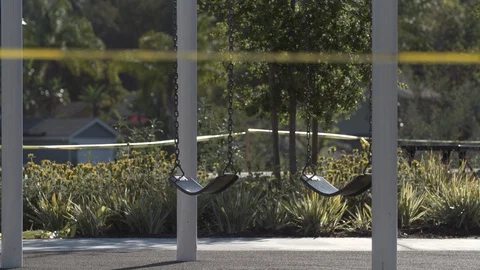 Empty Swings at Closed Playground Stock Footage 128607208