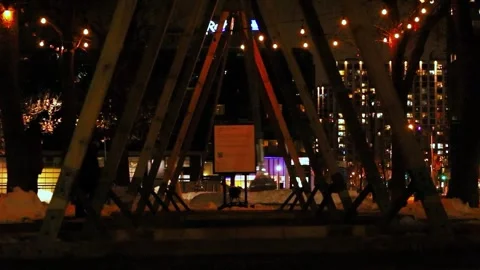 Empty swings moving on a playground—an eerie, people-free video at night.  Stock Footage 329154936