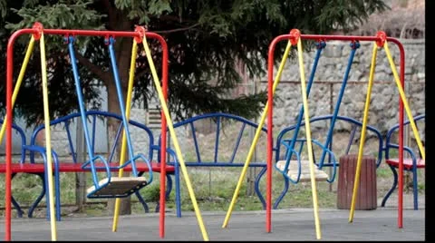 Empty swings in a playground Stock Footage 11151049