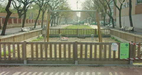 Empty swings set with caution tape to close off playground to children of coivd Stock-Footage 132069997