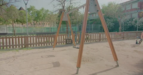 Empty swings set with caution tape to close off playground to children of coivd Stock-Footage 132070847