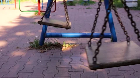 Empty swings set in an empty playground Stock Footage 202683697